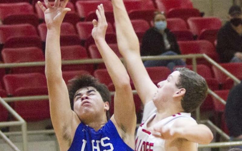 Tak Stinnett (shown shooting in a previous game) and Nate Borchardt (not pictured) had the Badgers’ only three-pointers in a district-opener victory with mostly two-point baskets. JEFF LOWE | DISPATCH RECORD