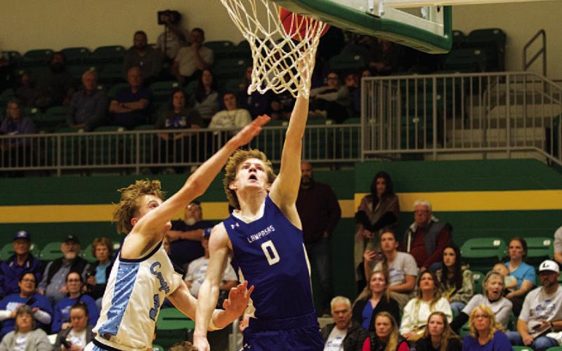 Peyton Sisson finishes at the rim over a China Spring defender. HUNTER KING | DISPATCH RECORD