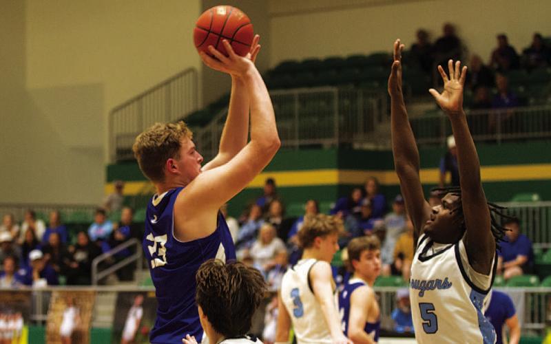 Beau Patterson shoots over a defender in the second half of Tuesday’s bi-district matchup. The seven-footer put up 31 points in the win over the Cougars. HUNTER KING | DISPATCH RECORD