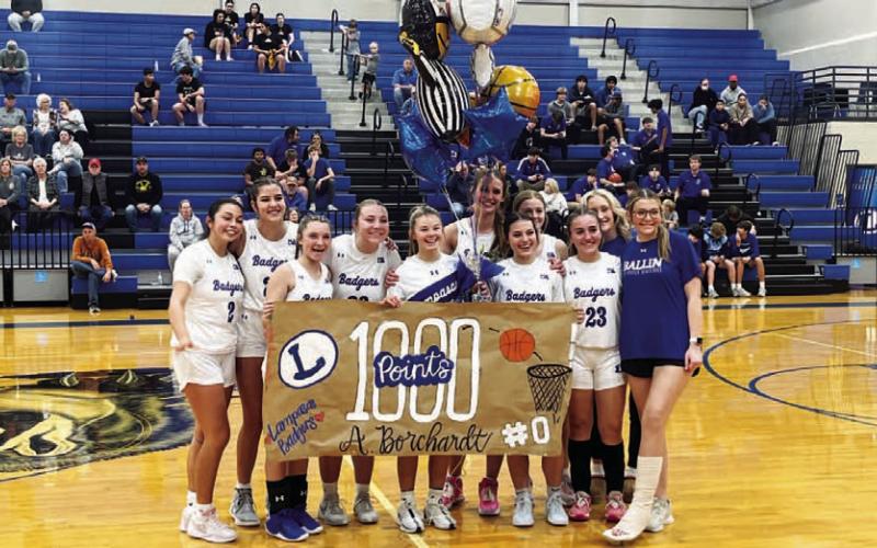 The girls’ basketball team celebrated Addison Borchardt reaching 1,000 career points ahead of a home game last week. HUNTER KING | DISPATCH RECORD