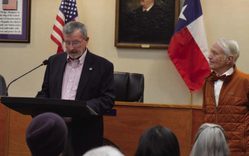 Municipal Court Judge Gene Isenhour, at left, speaks to those gathered in City Council Chambers for a ceremony Saturday morning to dedicate the municipal building in his name and Jack Clark’s. Clark, a CPA and financial consultant, stands to the right. ERICK MITCHELL | DISPATCH RECORD