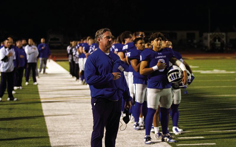 Troy Rogers and his team stand for the National Anthem prior to the playoff game. HUNTER KING | DISPATCH RECORD