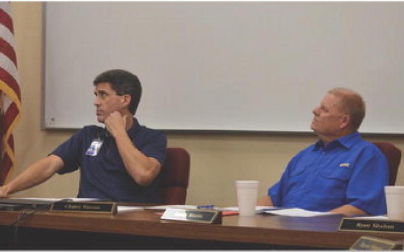 Lampasas ISD Superintendent Dr. Chane Rascoe, at left, and Board of Trustees President Randy Morris look on during a presentation at Monday’s meeting. ERICK MITCHELL | DISPATCH RECORD