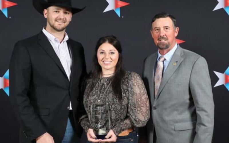 Heston and Stevie McBride were recipients of the Excellence in Agriculture award at the 88 th annual Texas Farm Bureau convention. They are shown here with TFB President Russell Boening, at right. COURTESY PHOTO | TEXAS FARM BUREAU MEDIA CENTER
