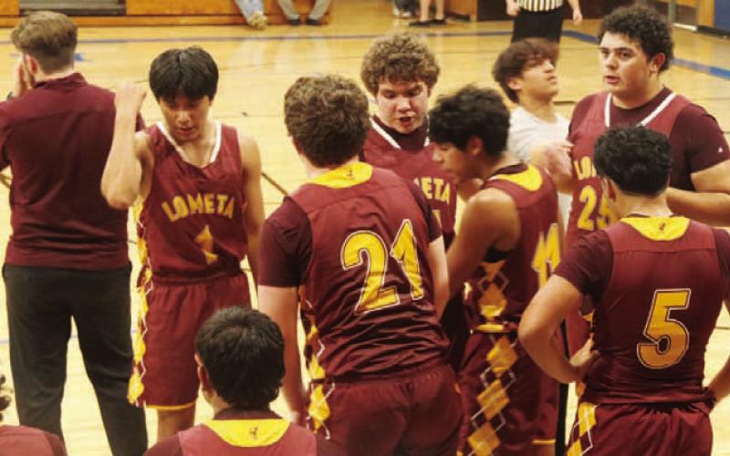 COURTESY PHOTO | AUSTIN MARTIN The Hornets gather around the bench during a road game this season.