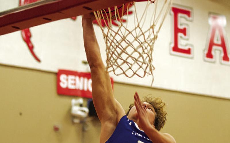 Haegan Oncken throws down a slam dunk on a fast break. HUNTER KING | DISPATCH RECORD