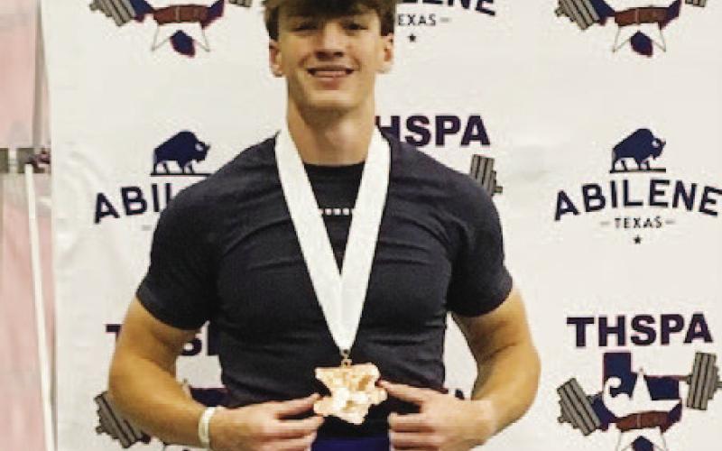 Aaron Everts shows off his medal for fifth place at the state powerlifting meet last weekend. COURTESY PHOTO