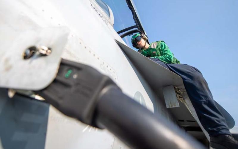 U.S. Navy photo by mass communication specialist seaman apprentice aaron Haro Gonzalez Logan Horn of Lampasas conducts maintenance work on an F/A-18E Super Hornet.