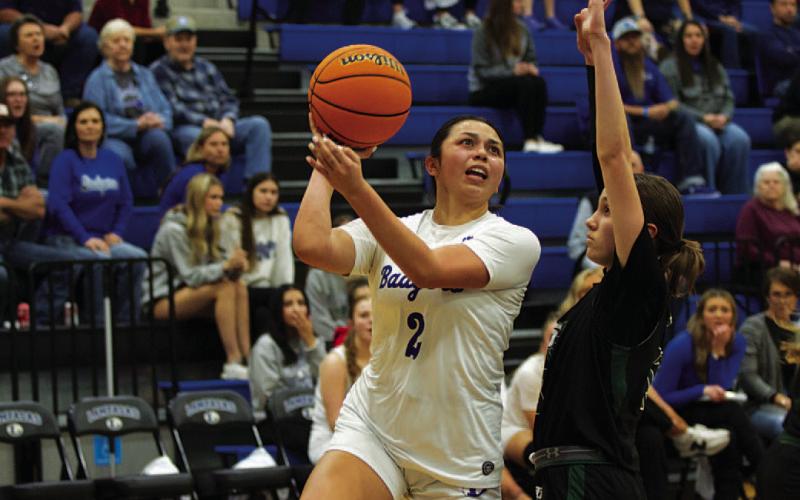 Johnnie Lewis drives past a defender and shoots over the outstretched arms. HUNTER KING | DISPATCH RECORD