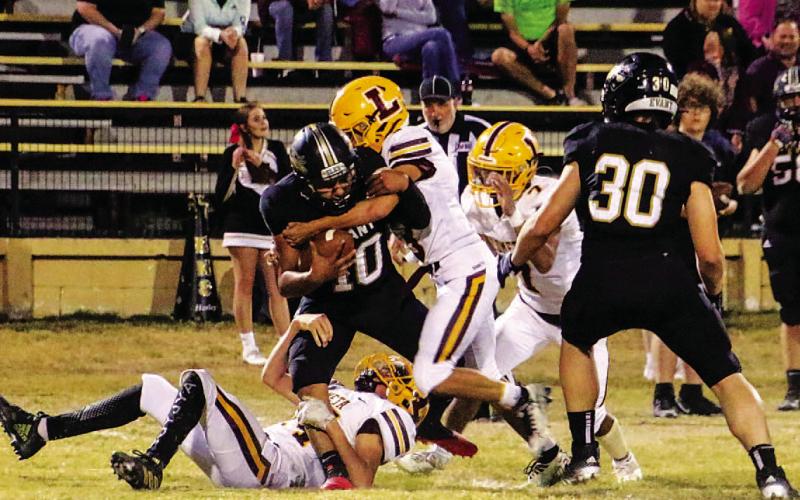 Stone Carr-Jones, Jordan Livesay and Leonel Caso combined to make this tackle during the win over Evant. COURTESY PHOTO | MEGAN LUSTY