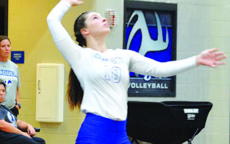 Emily Cain prepares to make a serve in a Lady Badgers home game. HUNTER KING | DISPATCH RECORD
