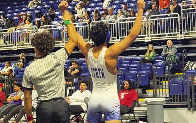 Kaiden Fernandez has his hand raised in victory during the Cy-Fair tournament. COURTESY PHOTO