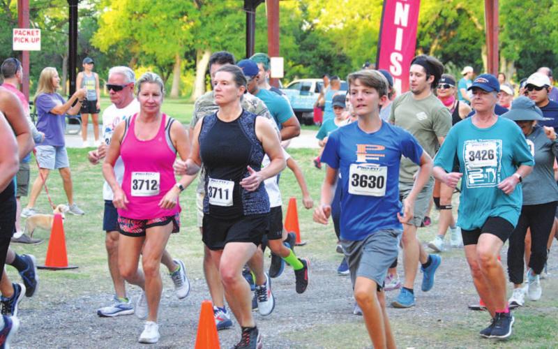 Runners start their race from Hancock Park Pavilion on Saturday. HUNTER KING | DISPATCH RECORD