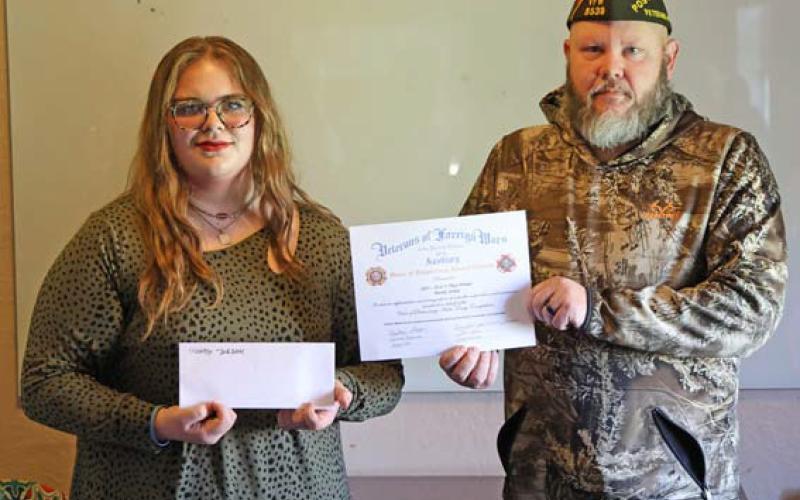 joycesarah mccabe | dispatch record Mandy Jordan, a 10th- grader at Learning Steady Academy, accepts a scholarship award from Lampasas VFW Commander Chris Adolph. Jordan had the winning audio essay answering the question, “What are the greatest attributes of our democracy?”