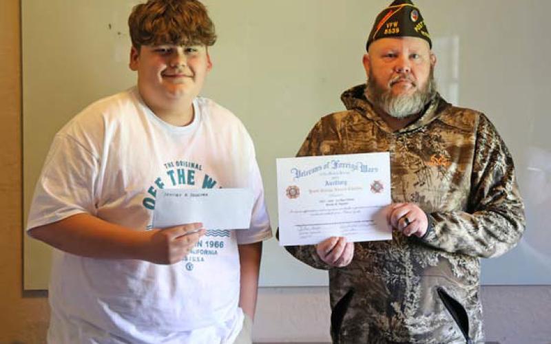 joycesarah mccabe | dispatch record Lampasas VFW Commander Chris Adolph awards Bentley Degetry, an eighth-grade student at Learning Steady Academy, a scholarship for his winning essay on the topic “How are you inspired by America?”