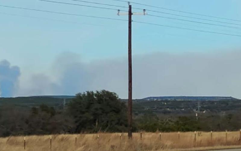 Smoke is seen on the horizon last week in rural Lampasas County. DISPATCH RECORD PHOTO