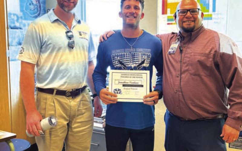 COURTESY PHOTO Lampasas High School selected Jonathan Vanliew, center, as its Teacher of the Month for August. Vanliew teaches biology and chemistry, as well as coaches. On hand to recognize him are Clay Phillips from Texas Farm Bureau Insurance, at left, and Assistant Principal Ryan Race.