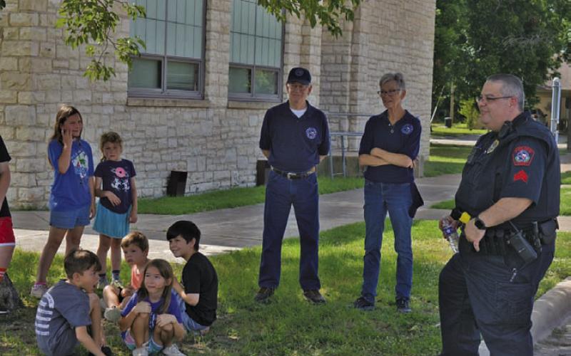 ERICK MITCHELL | DISPATCH RECORD Attendees of the Lampasas County Higher Education Center’s “Case of the Missing Mascot” wait their turn to learn more about police vehicles from Lampasas Police Department officers Steve Sheldon and Brandon English on Monday morning.