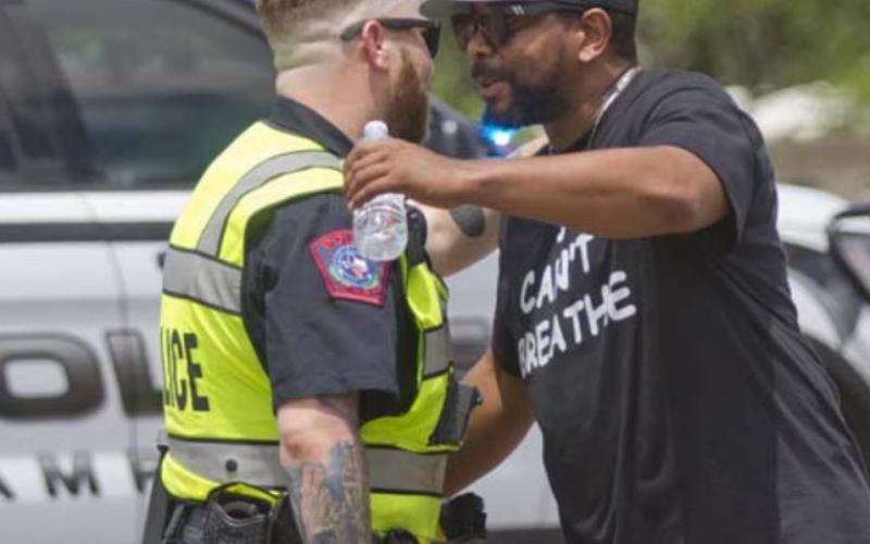 Lampasas police officer Josh Watson, left, and Russell Smith hug as Smith joined a march protesting the death of Minneapolis man George Floyd. Watson worked on traffic control during the march. Two local events in June that focused on Floyd and racial issues had “no incidents of any kind to include damage to property or violence,” Chief of Police Sammy Bailey said. FILE PHOTO