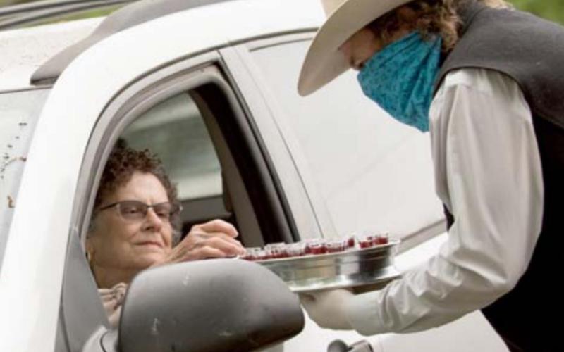 On Palm Sunday, Bobbie Hicks offers communion to his aunt, Orabeth Hicks, at Bend United Methodist Church. Stay-at-home orders lasted through Easter, prompting churches to offer drive-in and online services. Religious services were designated as essential in Texas, but parishioners in some other states faced months-long tensions with government over the right to assemble during the pandemic. FILE PHOTO