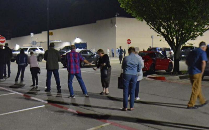 Shoppers flood the Walmart parking lot, waiting for the store to open one morning in March. Many businesses were ordered closed to in-person service in the early days of the coronavirus outbreak, and shelves were wiped clean of items including toilet paper. FILE PHOTO