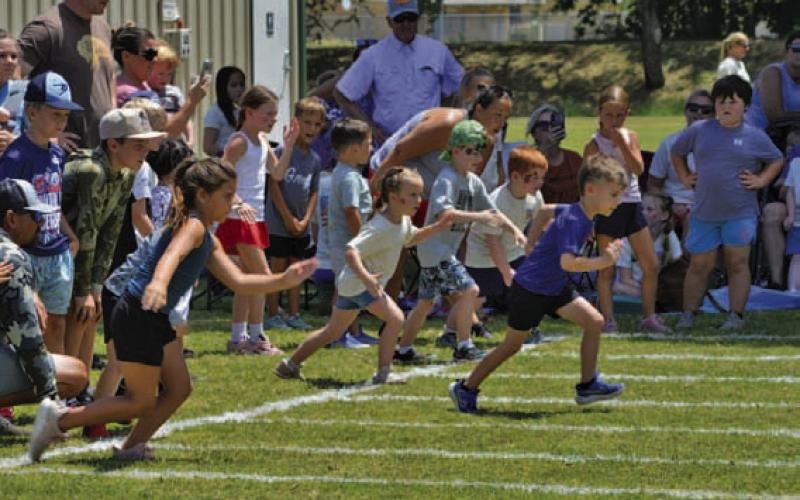 Children fire-off from the starting line during Kids’ Day relay races at the Gavin Garrett Soccer Complex on July 10. ERICK MITCHELL | DISPATCH RECORD