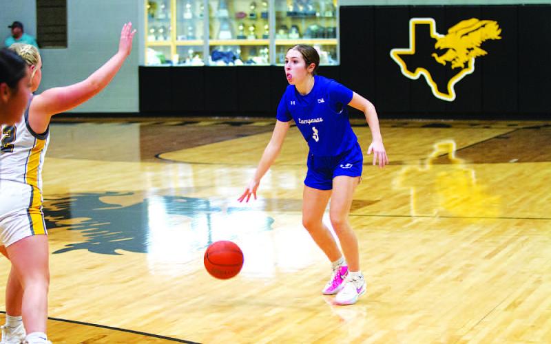 Kase Bumpus dribbles on the wing in a game where she scored 12 points. HUNTER KING | DISPATCH RECORD