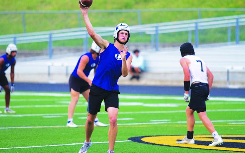 Calum Mitchell throws out to the flat late in Tuesday’s 7-on-7 action. HUNTER KING | DISPATCH RECORD