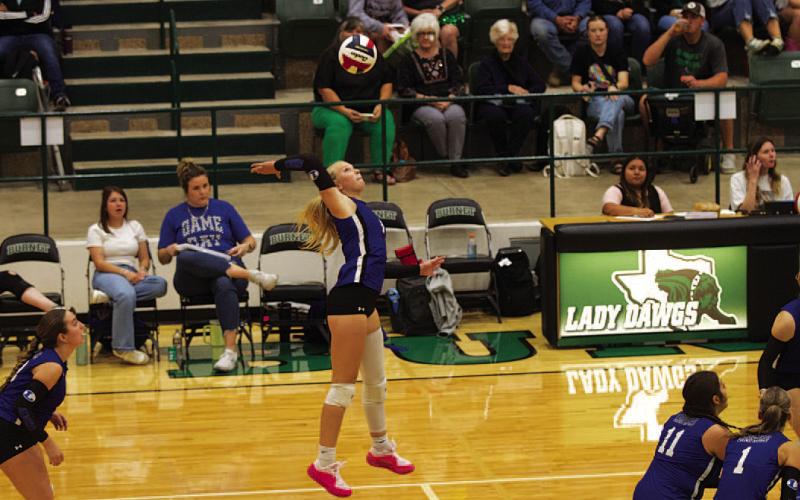 HUNTER KING | DISPATCH RECORD Brylie Turner leaps to spike the ball over the net against Burnet.