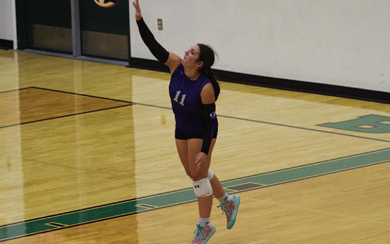 HUNTER KING | DISPATCH RECORD Julia Ybarra swings through a serve during the second set against the Lady Bulldogs.