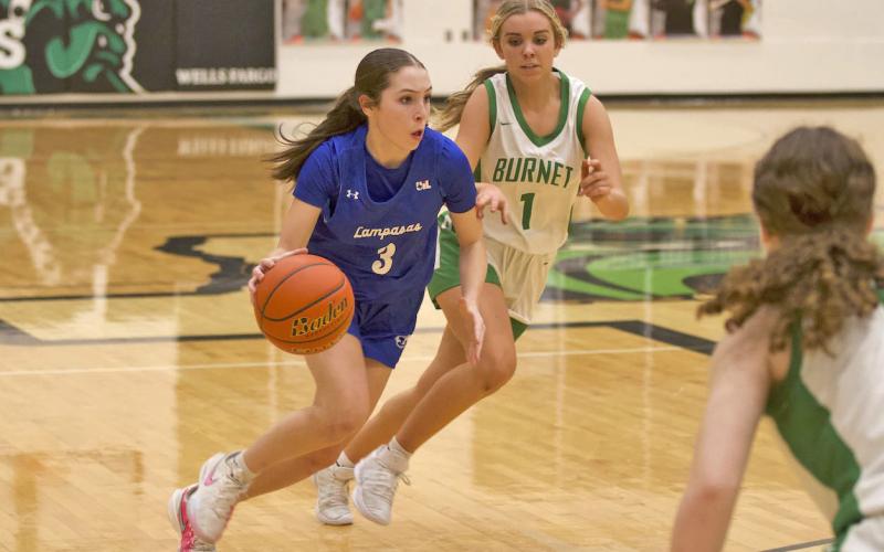Kase Bumpus dribbles past a Burnet defender during the Lady Badgers’ district victory on Friday. HUNTER KING | DISPATCH RECORD
