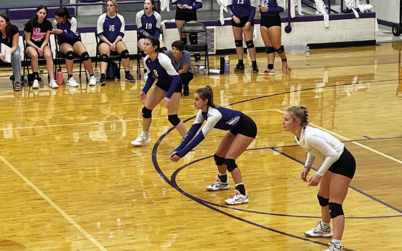 Gracey Ullevig, left, Kayli Syx and Bre Quarles step into position during the Marble Falls match. COURTESY PHOTO
