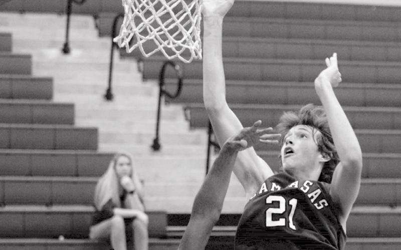 Kaeden Crawford (21) led Lampasas with 40 points over two games on Thursday. He is shown going for a basket against Lometa Hornet Dyllen Workmon. JEFF LOWE | DISPATCH RECORD