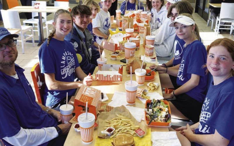 COURTESY PHOTO | KENNETH PEISER The Lampasas tennis team enjoys a meal at Whataburger after a successful trip to Burnet.
