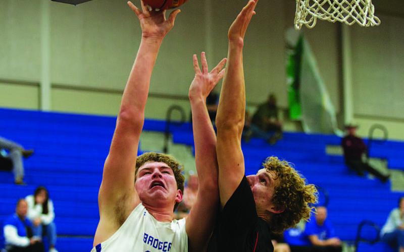 HUNTER KING | DISPATCH RECORD Beau Patterson goes up through contact for two of his 17 points Tuesday night.
