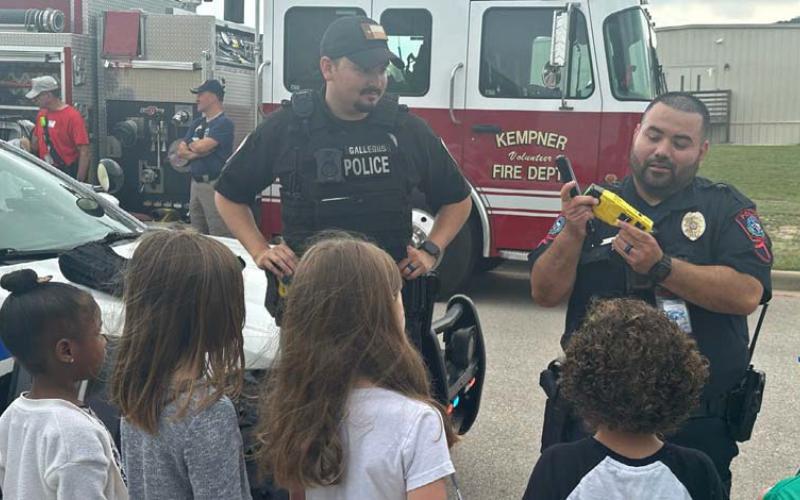 School Resource Officer Carlos Rodriguez, at right, demonstrates some of his law enforcement equipment to interested students. Courtesy photo