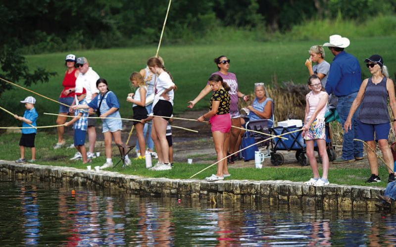 HUNTER KING | DISPATCH RECORD Kids lined the creek in W.M. Brook Park last Wednesday morning for the annual Kiddie Fishing Derby.