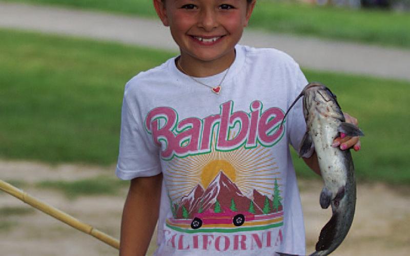 Logan Sellers shows off a catfish she caught last week. HUNTER KING | DISPATCH RECORD