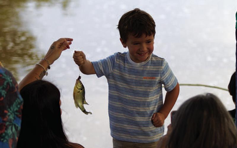 Kooper Hankins smiles with one of the many perch caught at the derby. HUNTER KING | DISPATCH RECORD