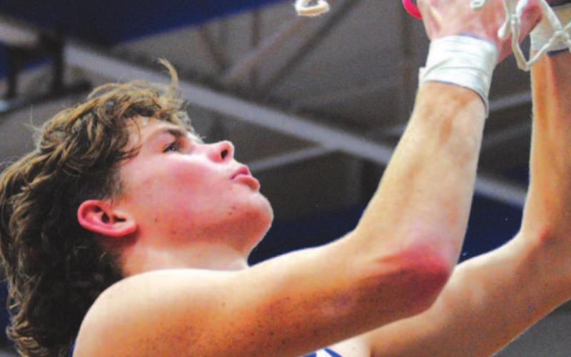 Nate Borchardt cuts down the net at the Badger Den after Lampasas won the district championship. HUNTER KING | DISPATCH RECORD