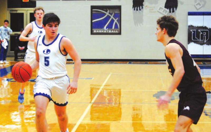 Dax Brookreson prepares to drive past a Brownwood defender during Tuesday’s game. HUNTER KING | DISPATCH RECORD