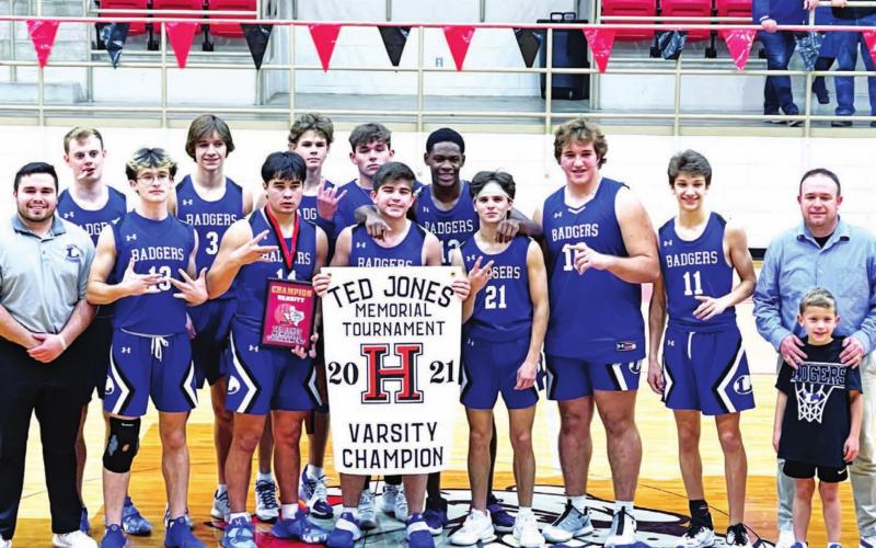 The Badgers pose with their trophy and banner as champions of the Hamilton varsity tournament. COURTESY PHOTO