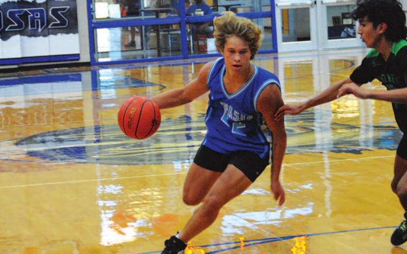 Haegen Oncken drives past a Burnet defender to the basket during Tuesday’s summer league game. HUNTER KING | DISPATCH RECORD