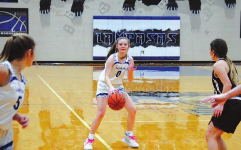 Addison Borchardt dribbles and motions for Hadley Oncken to move up the wing during the Lady Badgers’ win on Tuesday. HUNTER KING | DISPATCH RECORD