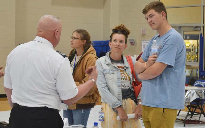 Bo Patterson and his mother, Amanda, visit at the Aviation Career Day with those in the aviation field about job options that are opening up. erick mitchell | dispatch record