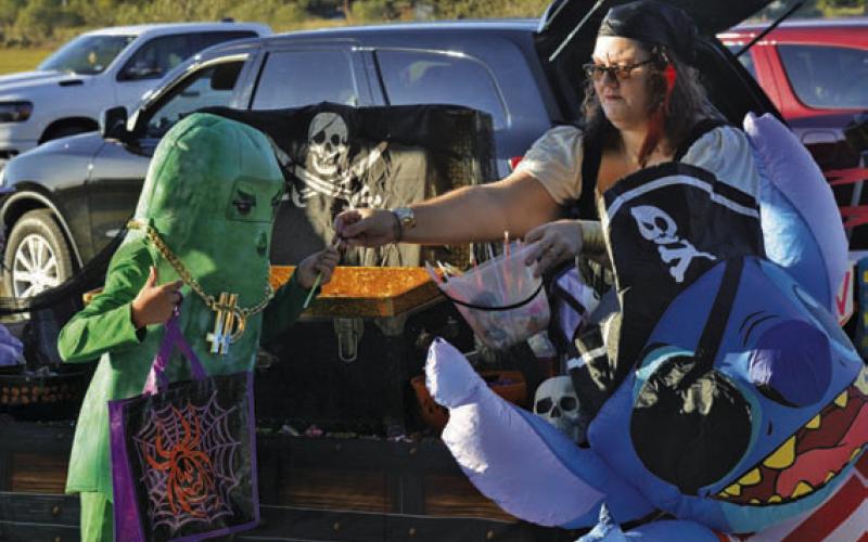 ERICK MITCHELL | DISPATCH RECORD Nothing says Halloween like a pickle-themed character from the video game “Fortnite” getting candy from a pirate.