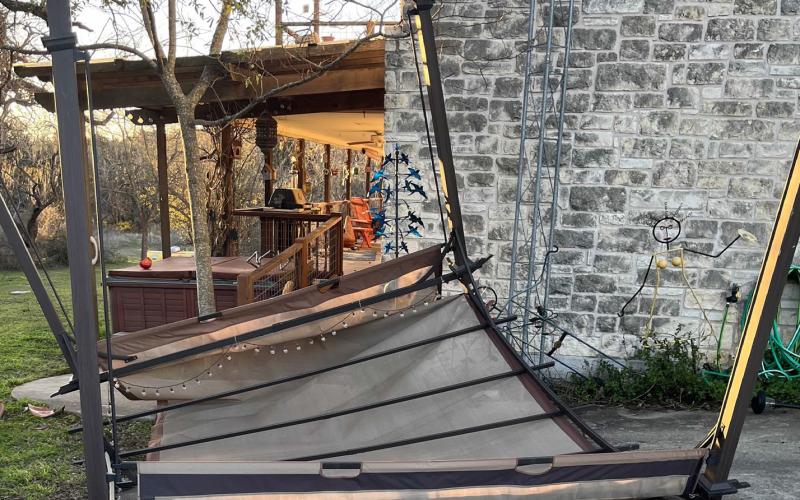 Strong winds flipped over this shade awning and carried it about 30 feet, county resident Dianna Hodges reported. Decorative items also were strewn about the yard, and a trampoline was another casualty of the high winds. COURTESY PHOTO