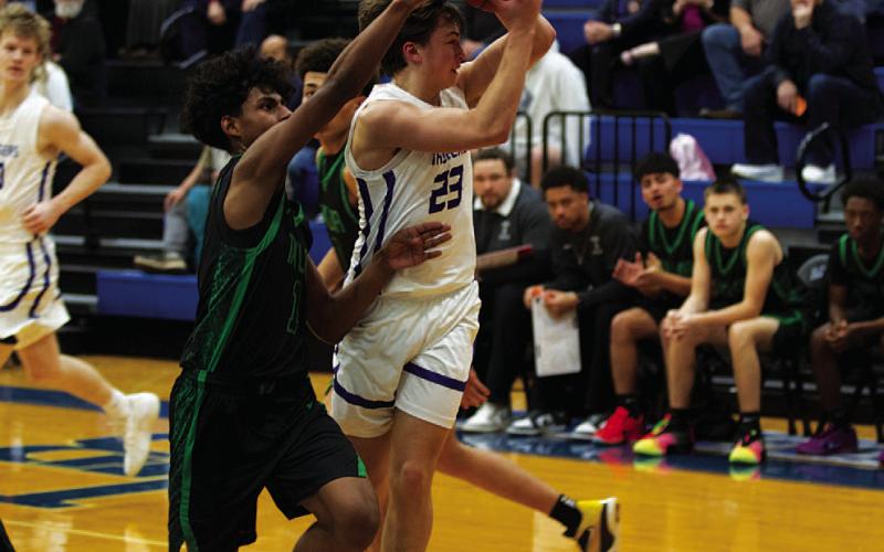 Ty Borchardt fights through contact from a Taylor defender to pass to a teammate. HUNTER KING | DISPATCH RECORD