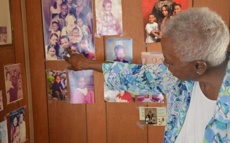 Clementine Walker looks over family photos in her home on Third Street. She retired last month after caring for patients for 56 years at Lampasas Nursing &amp;amp; Rehabilitation. MONIQUE BRAND | DISPATCH RECORD