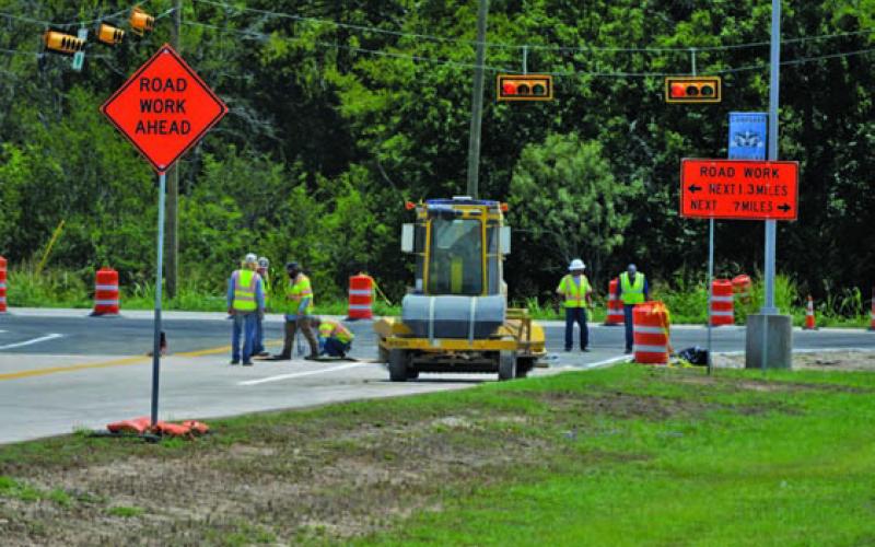 TxDOT contractors work to restripe the Lampasas High School entrance on Friday afternoon. ERICK MITCHELL | DISPATCH RECORD
